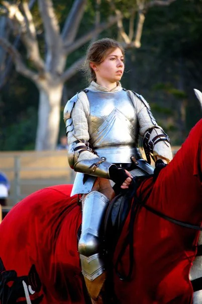She sat perfectly still in full plate armour while her horse shifted beneath her. I kept waiting for her to adjust. She never did.
