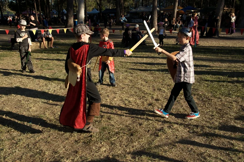 Two children having a sword fight at a medieval festival. It is the most natural image in the world and also one of the most joyful.