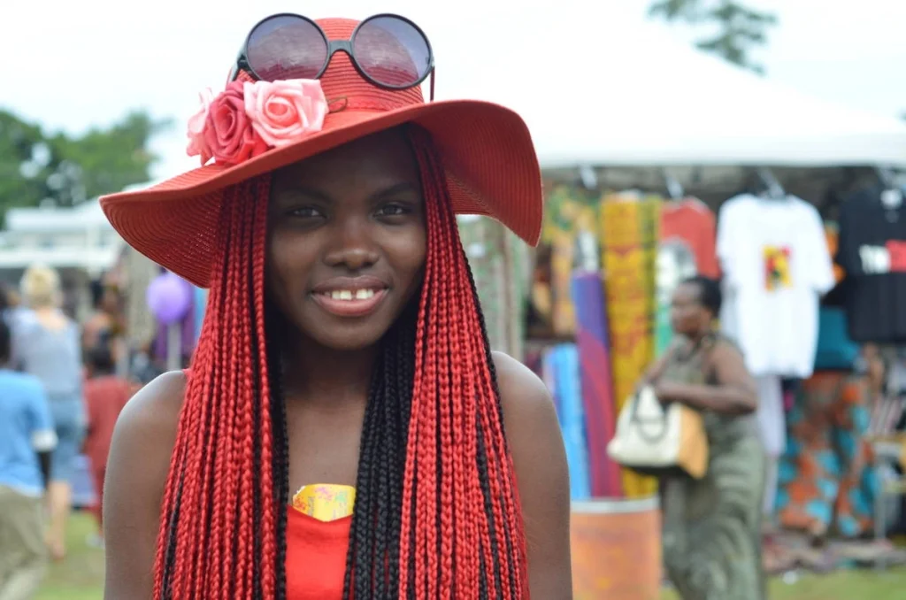 She wore red from her hat to her dress to her braids. When she turned to face me, every other element in the frame went quiet.