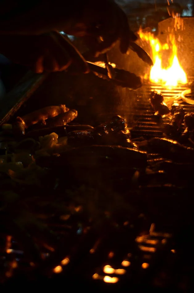 Fire at night is one of the oldest light sources a photographer has. The grill gave me everything — warmth, direction, depth.