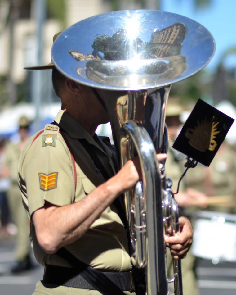 The city reflected in the bell of a tuba. I spent five minutes waiting to see if the reflection would resolve into something. It did.