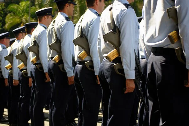 Uniformity is its own kind of beauty. A row of shoulders, each carrying the same responsibility, moving as one.