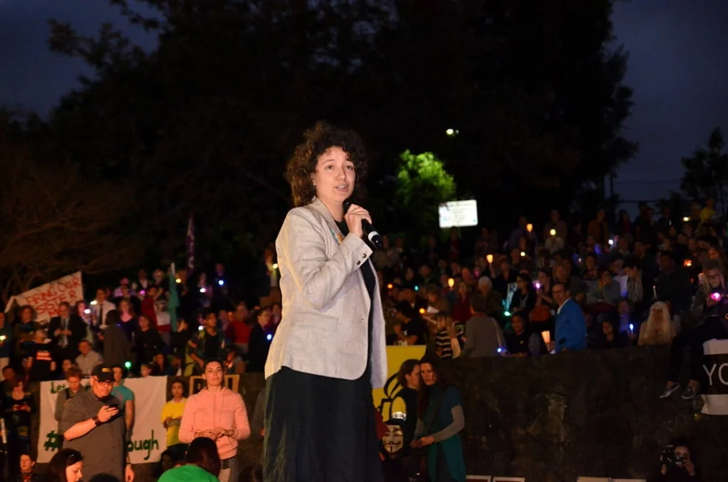 She spoke to a crowd of thousands from a small platform in the dark. Behind her, the candles stretched back as far as the lens could reach.