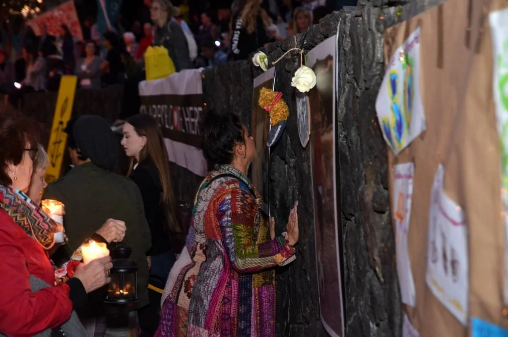 She pressed her hand against a face in a photograph on the memorial wall. I don't know whose it was. I did not ask.