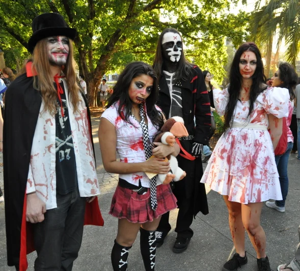 Four people in coordinated zombie costumes, assembled with enough craft to make you look twice at each one individually.