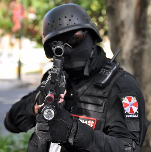 Full Umbrella Corporation tactical kit, aimed directly at the camera. Someone spent a very serious amount of time on that costume.