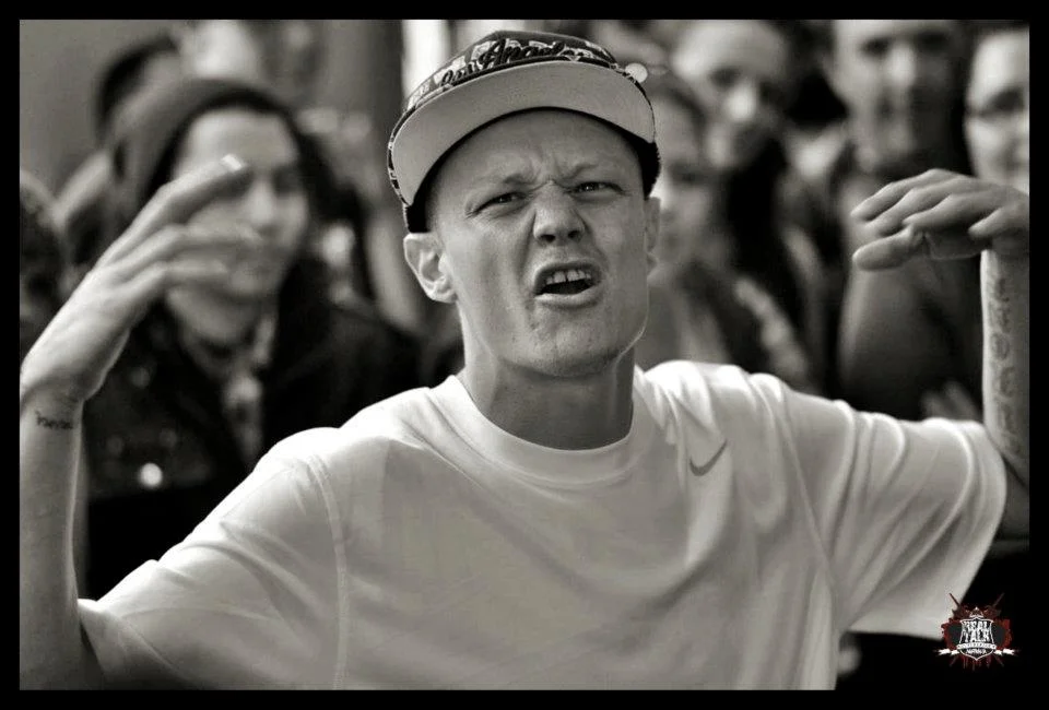 The face of a battler mid-round, every muscle employed. Black and white strips away everything except the expression, which is where the image lives.