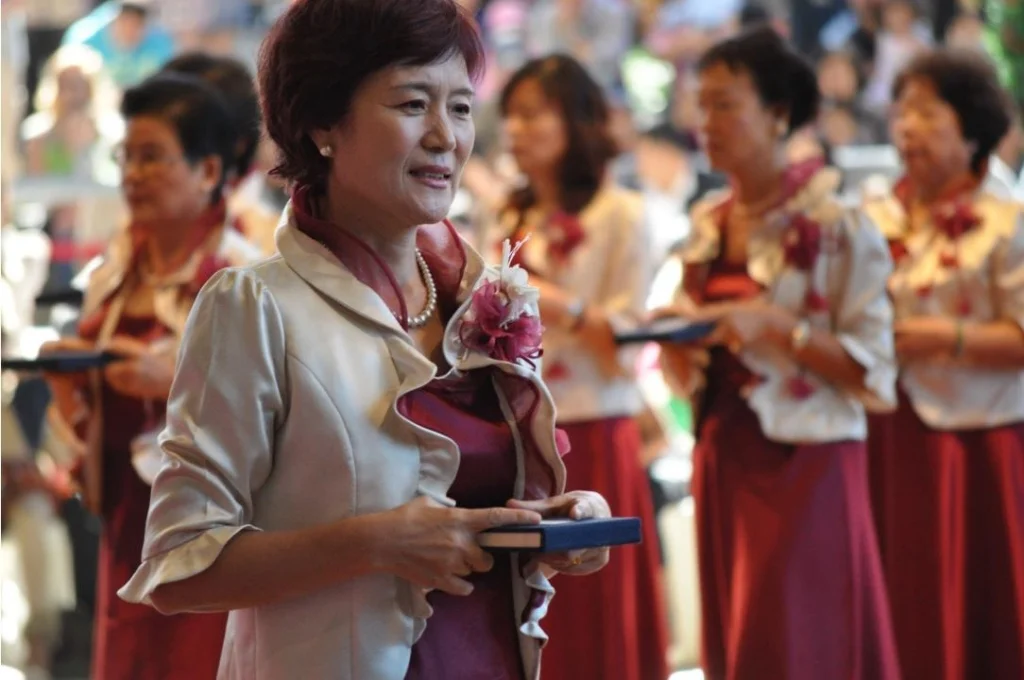 The smile in a formal procession is an unexpected gift. Everyone else was composed and still. She was genuinely happy to be there.