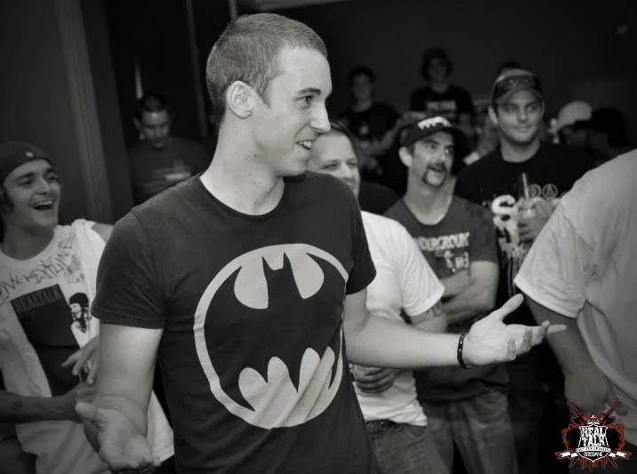 Mid-laugh, Batman shirt, completely unguarded. Some of the best portraits come when the performance is momentarily off.
