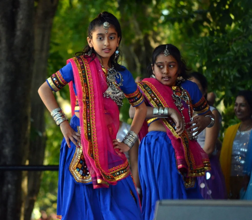 Two girls mid-routine, the older one already aware of her posture. The younger one is just dancing.