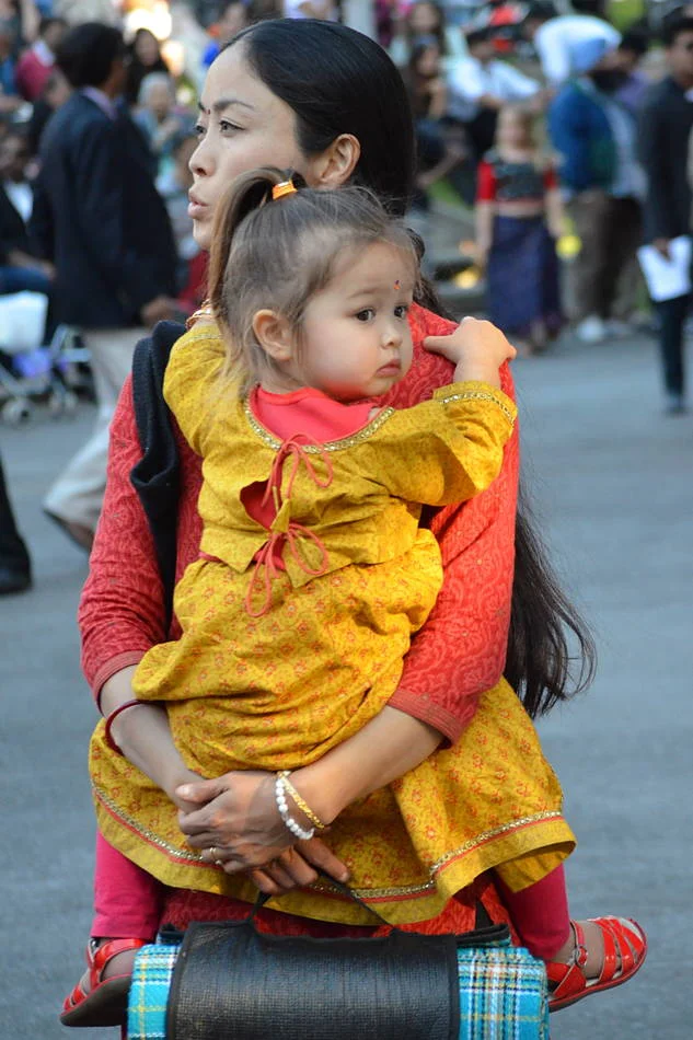 She was watching the stage, the child watching everything else. The best portraits at events come from people who have forgotten there is a photographer.