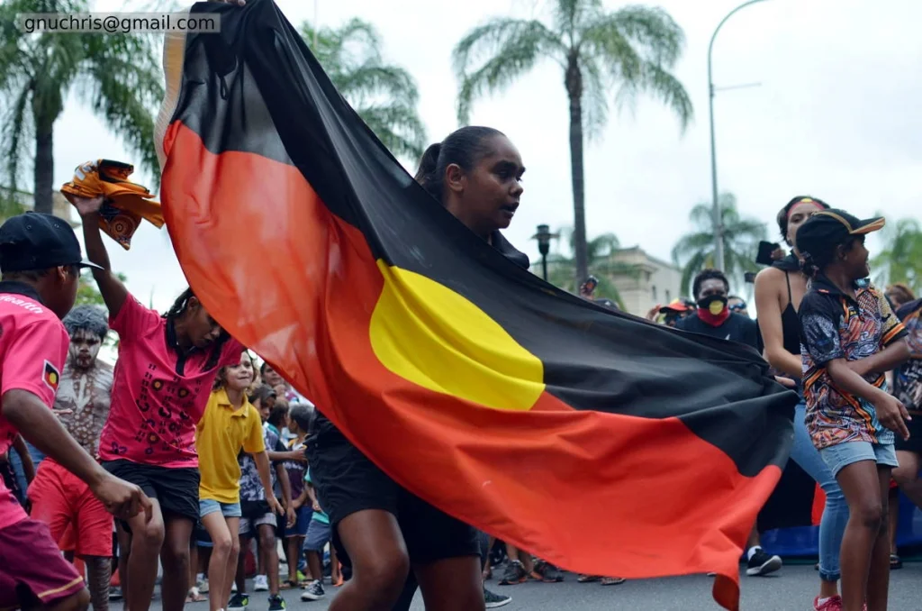 She carried the flag through the street and the flag filled the frame. The march behind her goes all the way back.