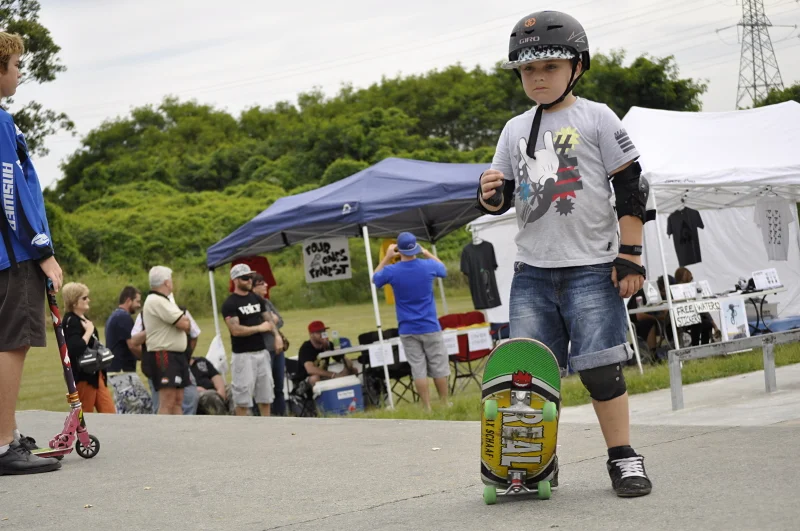 He's got the helmet and the board and the serious face. The competition tents are behind him. He is ready.