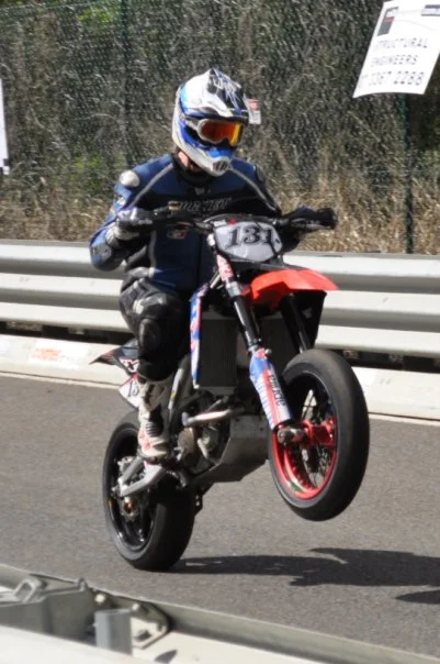 Show me a rider pulling a wheelie past the crowd and I will show you someone who has completely forgotten the camera exists. That is the shot.