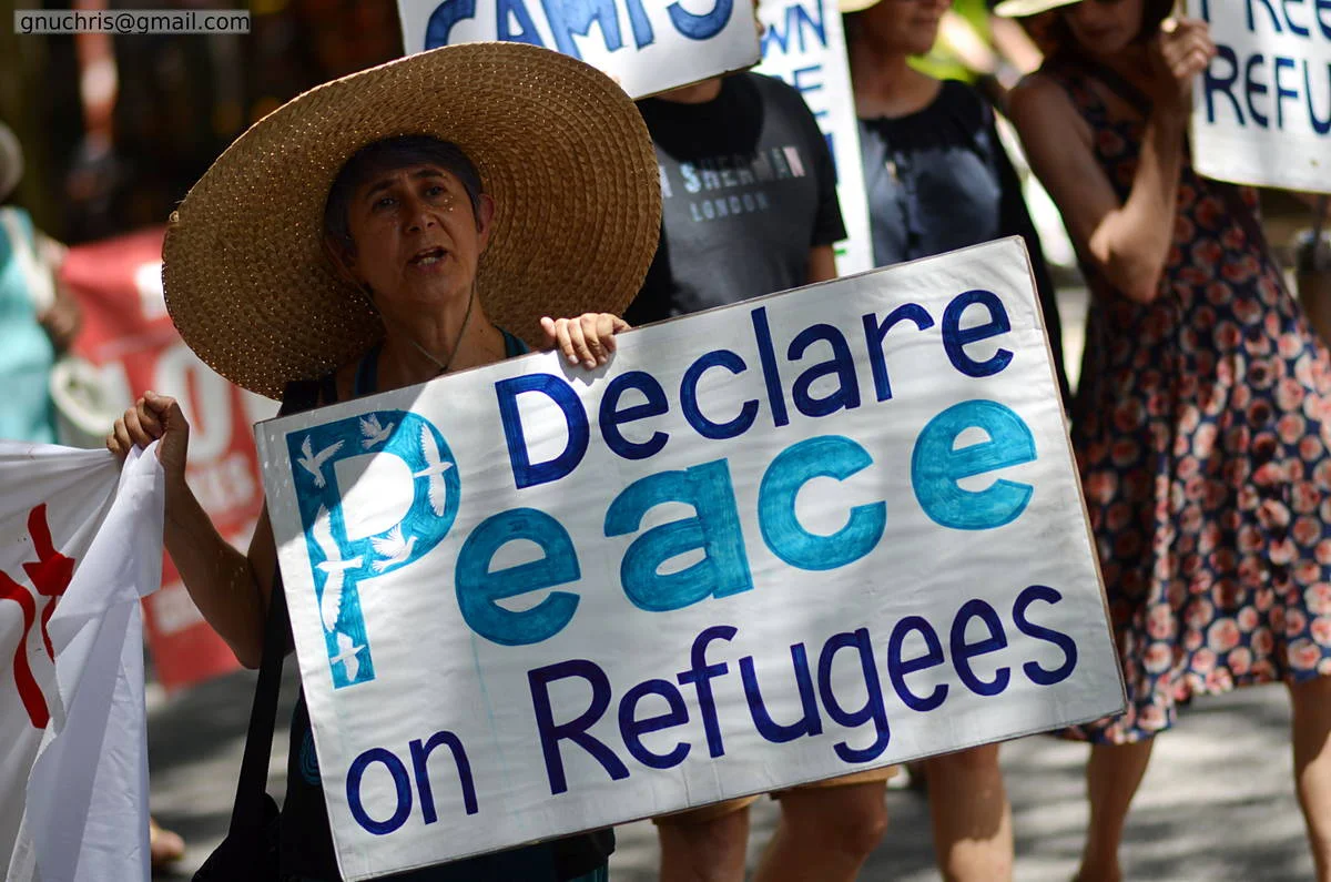 The most honest protest signs are the ones that say exactly what the person means, without irony, without cleverness — just the thing they believe, written out and held up.